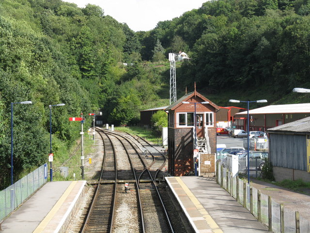 From the footbridge, the original GWR signalbox survives, with some reasonably unobtrusive replacement double-glazing, plus two lower-quadrant semaphores (unusually, complete with finials) which have been in these positions for many years. The siding is a vestigial remnant of the station&#039;s goods depot which closed in the early 1960s. To the left of the left-hand platform, vegetation has completely overtaken the small coaling point for steam locomotives.